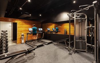 a man running on a treadmill in a gym